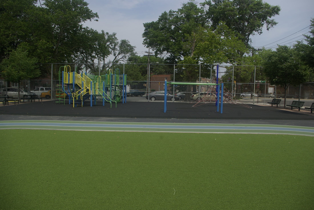 green turf in school yard with playground toys in background